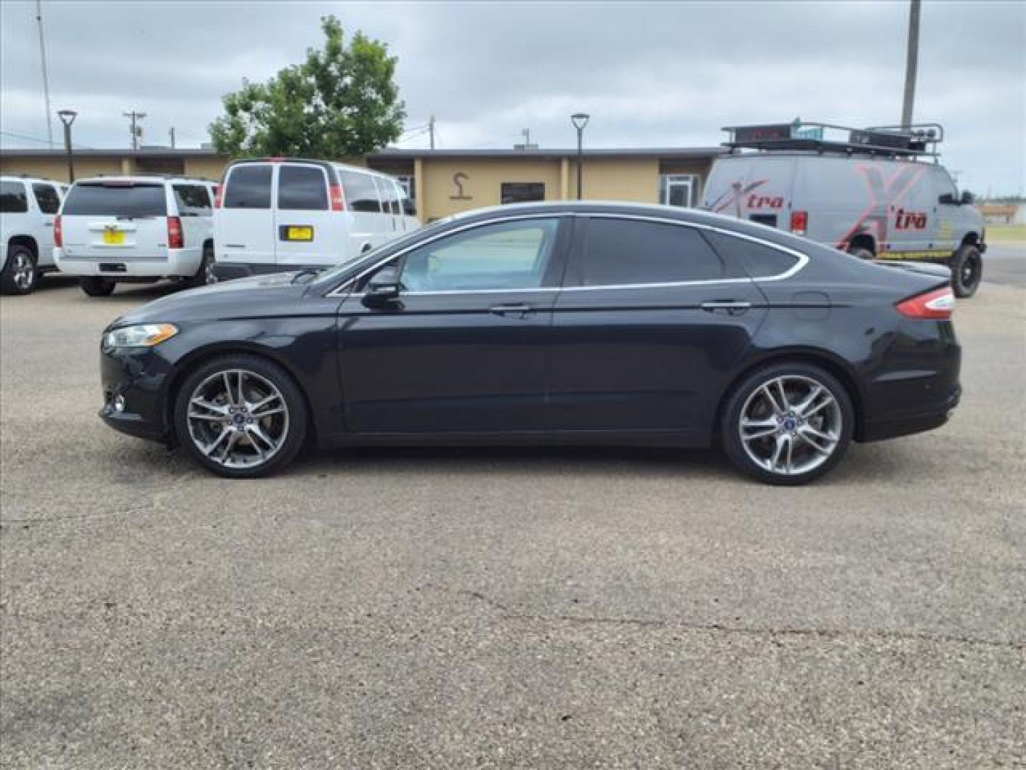 2013 Tuxedo Black Metallic Ford Fusion Titanium (3FA6P0K99DR) with an 2.0L EcoBoost 2.0L Turbo I4 240hp 270ft. lbs. Direct Injection engine, 6-Speed Shiftable Automatic transmission, located at 1401 N. Hobart, Pampa, TX, 79065, (806) 665-9872, 35.549953, -100.975098 - Photo#4