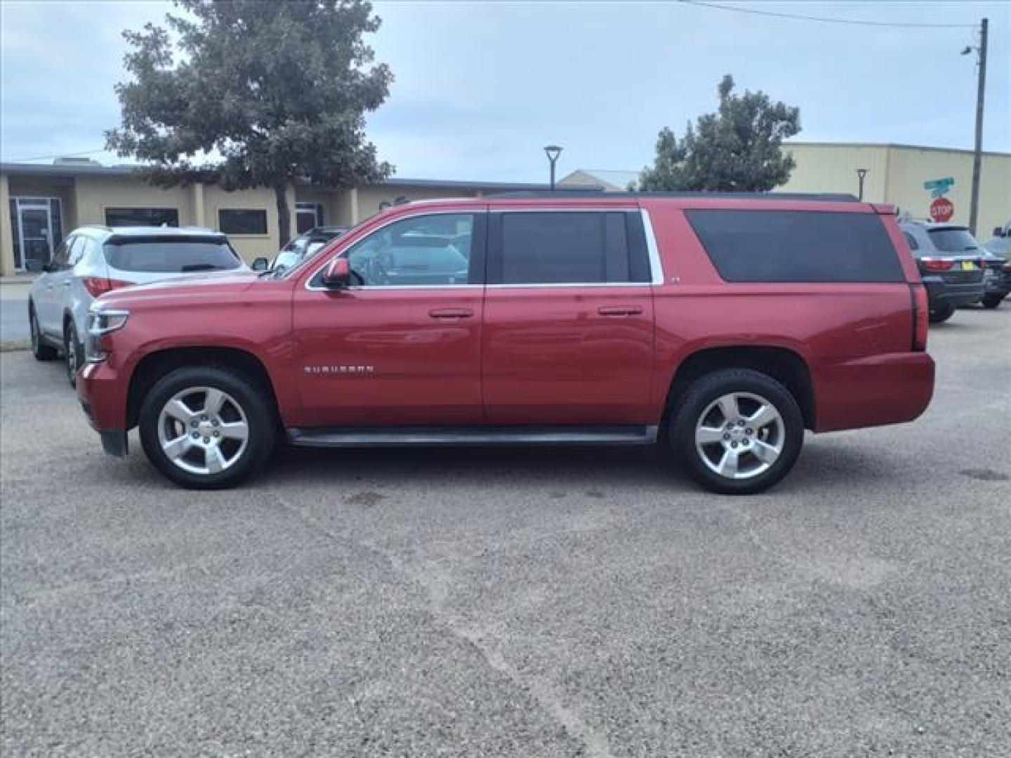 2015 Crystal Red Tintcoat Chevrolet Suburban LT (1GNSKJKC5FR) with an 5.3L EcoTec3 5.3L Flex Fuel V8 355hp 383ft. lbs. Direct Injection engine, 6-Speed Shiftable Automatic w/Overdrive transmission, located at 1401 N. Hobart, Pampa, TX, 79065, (806) 665-9872, 35.549953, -100.975098 - Photo#4